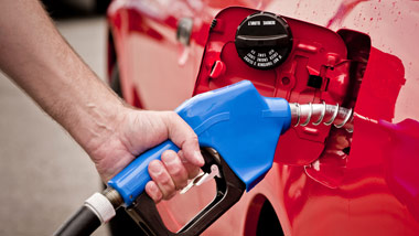 Man gassing up a red car